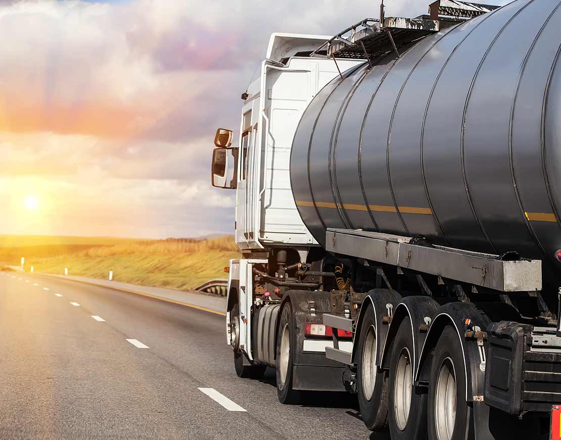 Liquid being transported by bulk freight truck on highway — bulk logistics