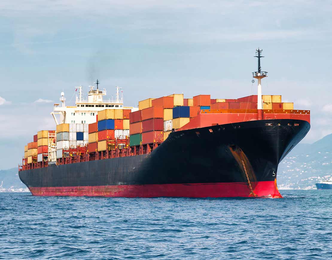 Cargo ship transporting cargo containers across the ocean – water logistics