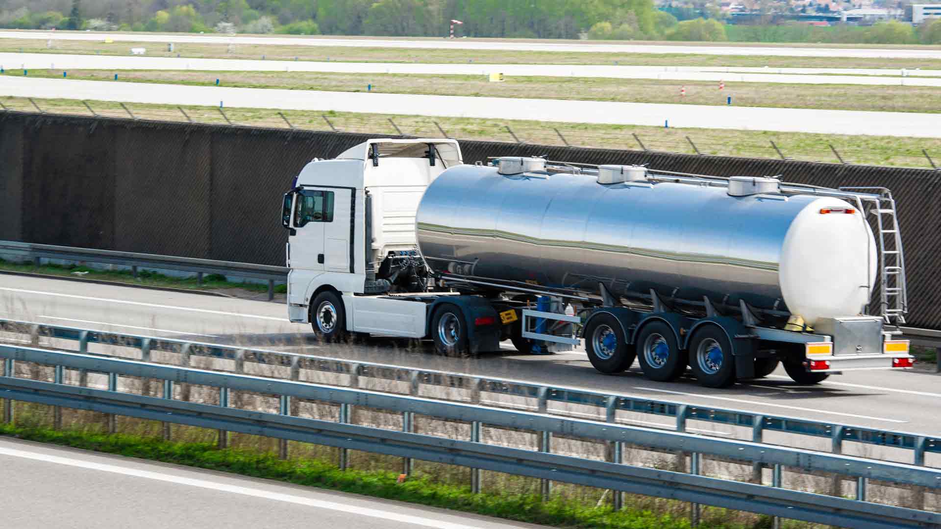 liquid bulk transport truck driving on highway transporting goods — bulk logistics