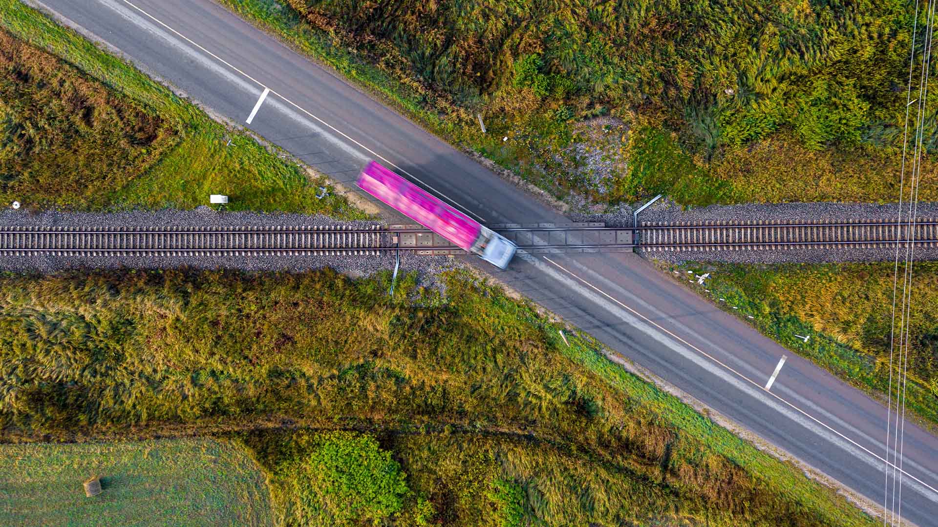 Photo of a freight truck passing over a rail road