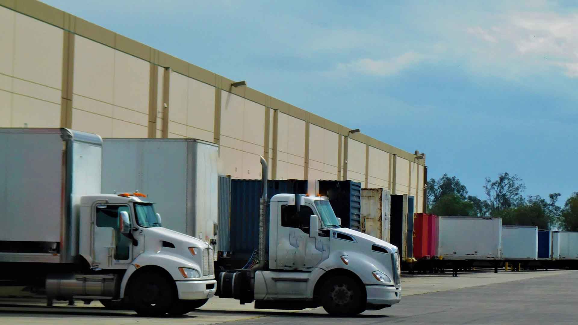 Photo of a freight truck unloading at a warehouse